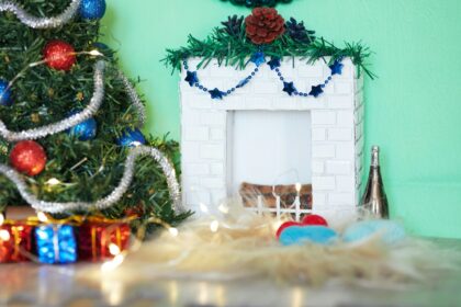 red and green wreath on white wooden wall