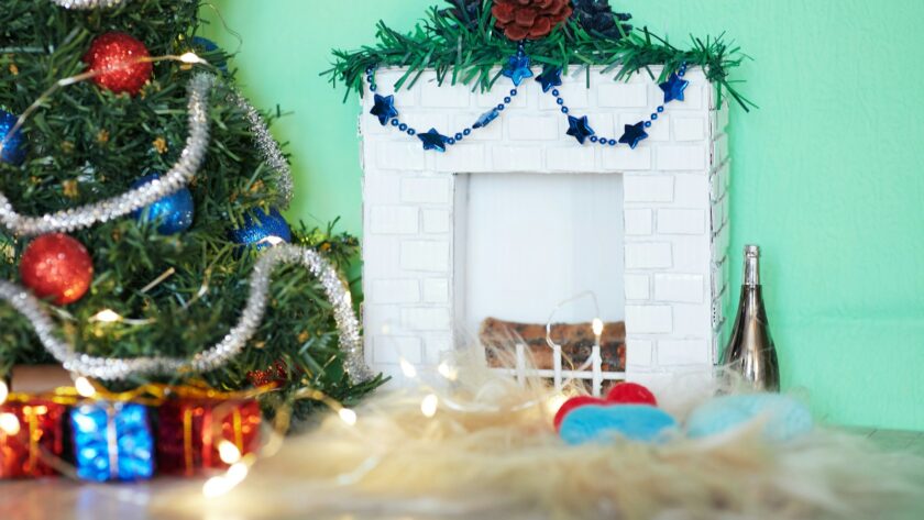 red and green wreath on white wooden wall